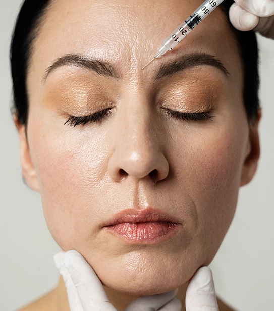Close-up of a woman receiving anti-wrinkle injection on forehead by a medical professional
