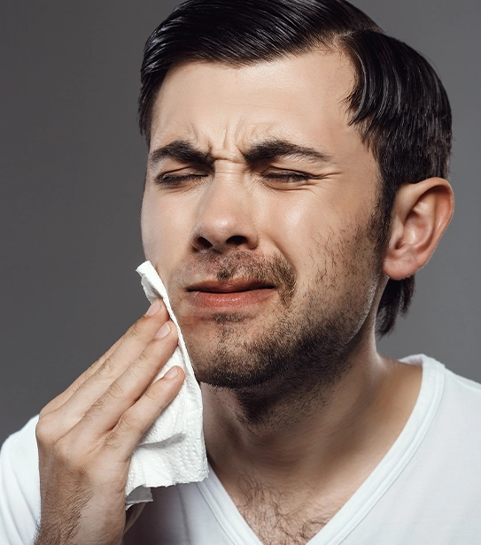 Man experiencing jaw pain holding cheek, concept of TMJ splint treatment for TMJ disorder